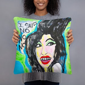 May include: A colorful throw pillow with a painting of a woman with black hair and a bright green, blue, and white background. The text "I SAID NO NO NO" is written in white on a blue background.
