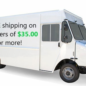 May include: A white delivery truck with the text "FREE shipping on all orders of $35.00 or more!" on the side. The truck has a boxy design with a front cab, side door, and large windshield.