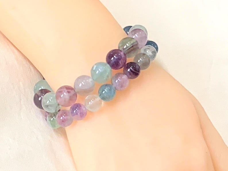 Fluorite Gemstone bracelet features Grade AA+ Fluorite beads that display the stunning range of colors and patterns for which Fluorite is renowned.