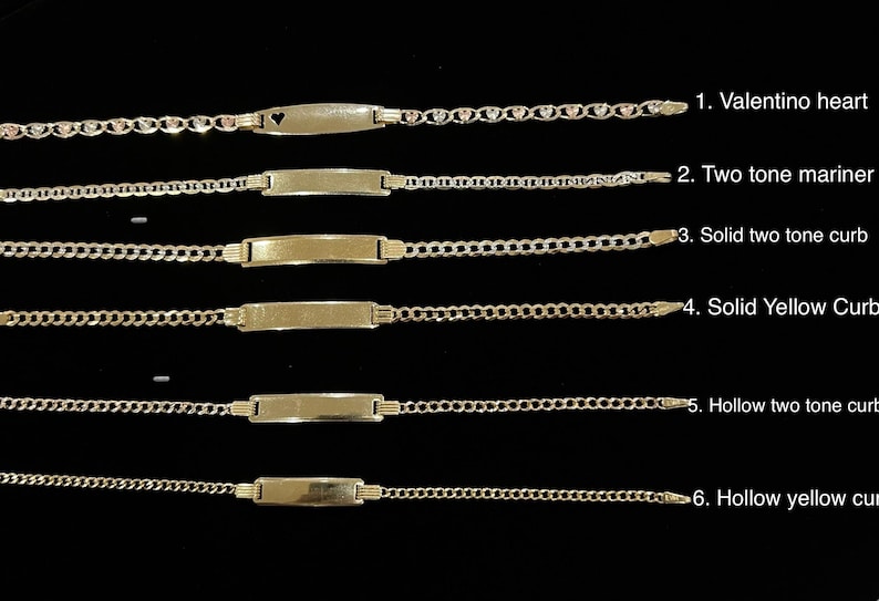 May include: A collection of six gold-toned ID bracelets, each with a different chain style and plate design. The styles include a heart-accented chain, two-tone mariner, solid two-tone curb, solid yellow curb, hollow two-tone curb, and hollow yellow curb.