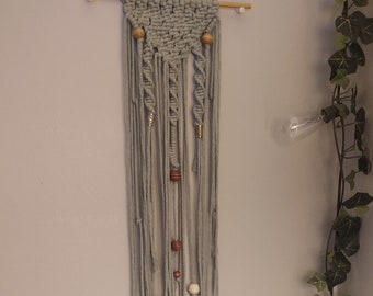 Sage green macrame wall hanger.