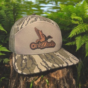 May include: A camouflage trucker hat with a brown leather patch featuring a flying duck and the text "Only Ducks".