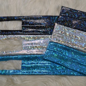 May include: Four iridescent fabric strips in black, silver, blue, and turquoise. The fabric has a textured, scaly appearance.