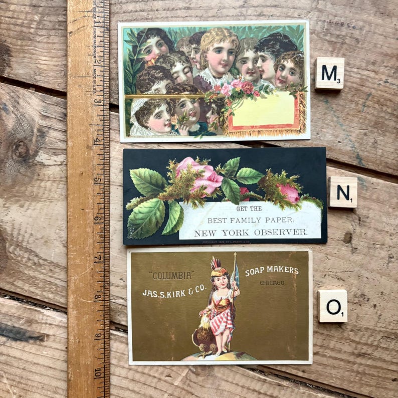 May include: Three vintage advertising cards. The top card features a group of children. The middle card has pink roses and the text "GET THE BEST FAMILY PAPER. NEW YORK OBSERVER." The bottom card shows a Native American figure and the text "COLUMBIA JAS.S.KIRK & CO. SOAP MAKERS CHICAGO."