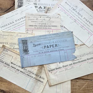May include: A collection of vintage paper ephemera, including invoices and receipts. The documents feature faded ink, handwritten notes, and the names of businesses like Hubbard & Anderson. The papers are in various sizes and colors.