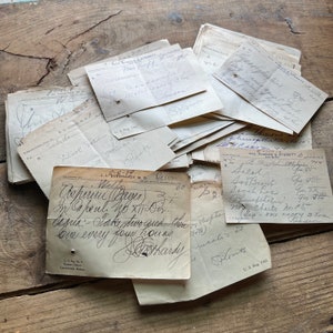 May include: A close-up of a stack of vintage medical prescription forms with handwritten notes. The forms are yellowed with age and have a faded, worn look. The text on the forms is in cursive handwriting and includes the names of medications, dosages, and instructions. The forms are a glimpse into the past and the history of medicine.