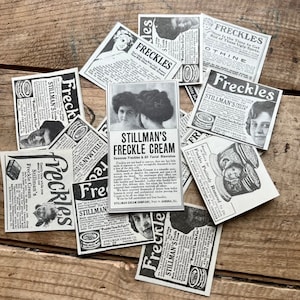May include: A collection of vintage advertisements for Stillman's Freckle Cream, a product that claims to remove freckles and other facial blemishes. The ads feature black and white images of women and text that promotes the product's effectiveness.
