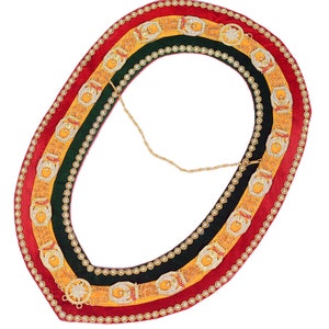 May include: A gold and red velvet collar with a chain and decorative embellishments. The collar is trimmed with rhinestones and features a repeating pattern of stars and crescents.