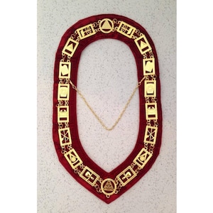 May include: Gold Masonic collar with a red velvet backing and a chain. The collar features a series of square links with various Masonic symbols.