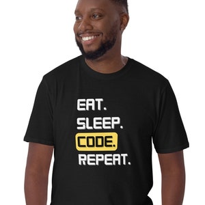 May include: Black t-shirt with white text that reads "Eat. Sleep. Code. Repeat." The word "Code" is highlighted in yellow.
