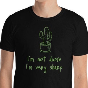 May include: Black t-shirt with a green cactus illustration and the text "I'm not dumb I'm very sharp".