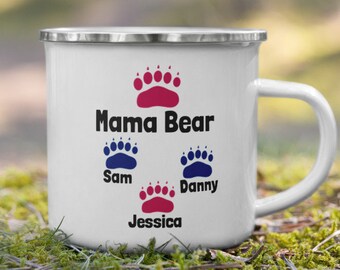 May include: White enamel camping mug with a red paw print and the text "Mama Bear" and three blue paw prints with the names "Sam", "Danny", and "Jessica" underneath.