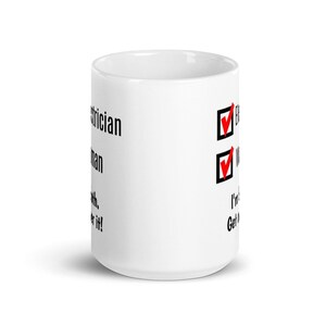 May include: White ceramic mug with black text that reads "Electrician.  I'm not a magician.  But I can make it work.  Get over it!"  Two checkboxes with red checkmarks are to the right of the text.