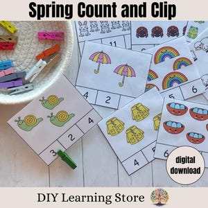 May include: A set of printable spring-themed counting cards featuring images of snails, umbrellas, rainbows, raincoats, and eggs. The cards are designed for use with clothespins to help children learn to count.