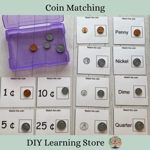 May include: A set of 10 cards for a coin matching game. Each card has a picture of a US coin and the value of the coin written on it. The cards are white with black text and borders. The coins are arranged in a plastic container.