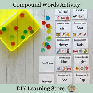 May include: A yellow plastic container with colorful circular counters and compound word flashcards. The flashcards feature illustrations and words like "Wheel," "Mail," "Honey," "Star," "Sea," and "Pop." The text "Compound Words Activity" is at the top.