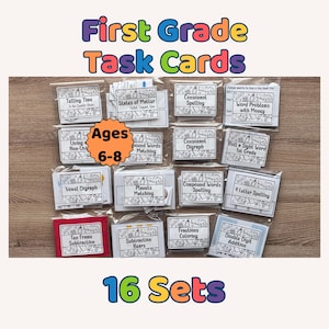 May include: A collection of 16 sets of First Grade Task Cards for ages 6-8. The cards are in clear plastic packaging and cover topics like telling time, spelling, and math. The title "First Grade Task Cards" is in colorful letters.