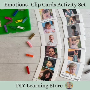 May include: A set of printable clip cards featuring children expressing different emotions. The cards are printed on white cardstock and feature a variety of children with different facial expressions. The cards are labeled with the emotions they represent, such as "confused" and "excited".