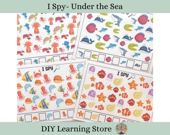 May include: Four printable "I Spy" game cards featuring underwater sea creatures. The cards have a variety of colourful sea creatures including seahorses, jellyfish, starfish, and more. Each card has a magnifying glass icon and a blank space for writing the number of each creature found.