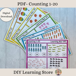 Może przedstawiać: Pięć kolorowych, drukowanych mat edukacyjnych do liczenia od 1 do 20. Każda mata ma inny motyw z obrazkami przedmiotów, takich jak tęcze, liście, meduzy, marchewki i robaki. Maty są oznaczone "Learning Mat #" i zawierają tekst "Counting 1-20".