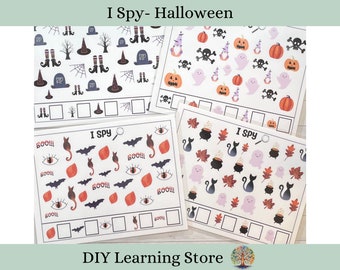 May include: Four printable "I Spy" game cards featuring Halloween-themed images. The cards include images of ghosts, pumpkins, bats, cats, witches, cauldrons, and more. Each card has a space for children to write down how many of each item they can find.