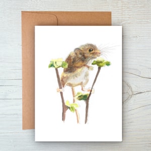 May include: A watercolor greeting card featuring a detailed illustration of a small brown mouse perched on a branch with green leaves. The card is paired with a brown envelope, creating a natural and earthy aesthetic.