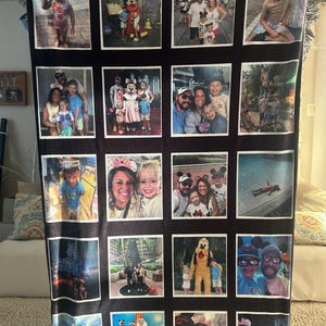 May include: A white ceramic mug with a black handle and the text "But First, Coffee" in a bold, black font. The mug is set against a blurred background, suggesting a cozy setting.