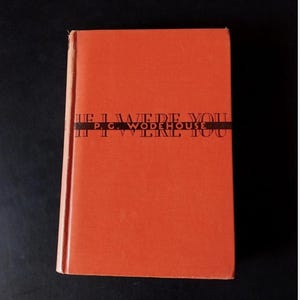 May include: A hardcover book with a solid orange cover. The title IF I WERE YOU and the author name P. G. WODEHOUSE are printed in black capital letters across a horizontal black band centered on the front cover of the book.