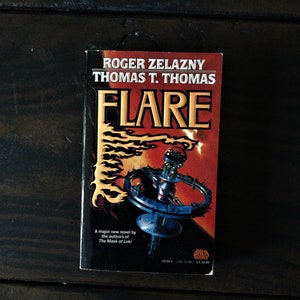 May include: A paperback book titled "Flare" by Roger Zelazny and Thomas T. Thomas. The cover features a futuristic space station with flames in the background.