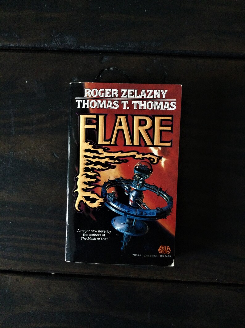 May include: A paperback book titled "Flare" by Roger Zelazny and Thomas T. Thomas. The cover features a futuristic space station with flames in the background.