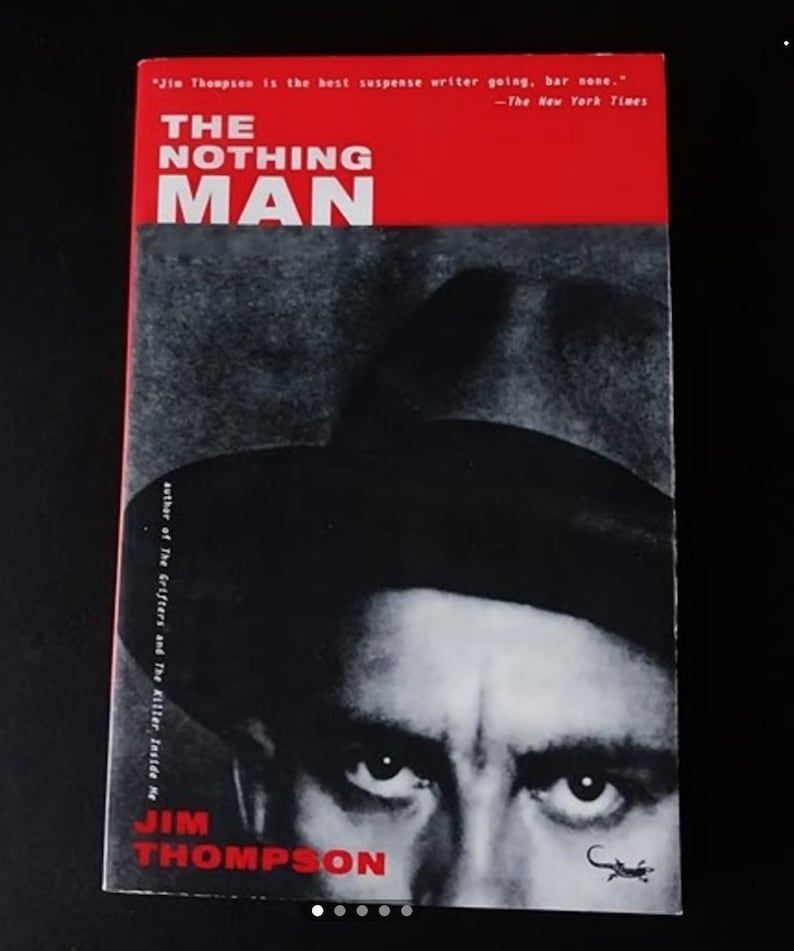 May include: A book cover with a red background and the title "The Nothing Man" in white text. The author, Jim Thompson, is listed below the title in white text. The cover features a black and white photo of a man's face with a hat, looking directly at the viewer.
