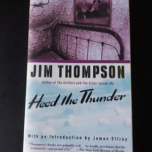 May include: A book cover with a blue sky background and the title "Heed the Thunder" in black text. The author's name, Jim Thompson, is written in white text above the title. The book is by the author of "The Grifters" and "The Killer Inside Me".