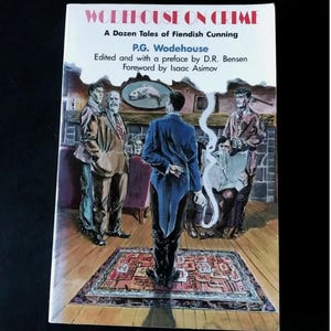 May include: A paperback book titled Wodehouse on Crime: A Dozen Tales of Fiendish Cunning by P.G. Wodehouse, edited by D.R. Bensen with a foreword by Isaac Asimov. The cover features a colorful illustration of several figures in a room.