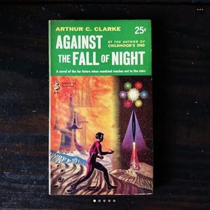 May include: A vintage paperback book cover with a green background and the title "Against the Fall of Night" by Arthur C. Clarke. The cover features a colorful illustration of a futuristic city and a spaceship.