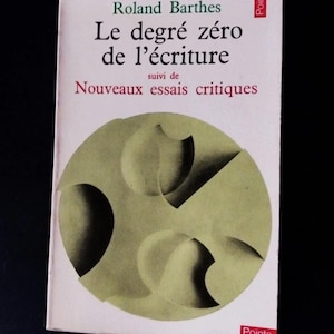 May include: A paperback book titled Le degré zéro de l'écriture suivi de Nouveaux essais critiques by Roland Barthes. The white cover features a large, centered olive green circle containing abstract, shaded geometric shapes and the word Points.