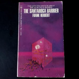 May include: A vintage paperback book titled "THE SANTAROGA BARRIER" by Frank Herbert. The cover features a purple and pink abstract illustration of a geometric shape with a hole and a white sphere. The book is a Berkley Medallion Book.