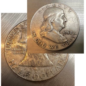 May include: A silver 1958 Franklin half dollar coin. The obverse features a profile of Benjamin Franklin with the inscriptions "LIBERTY", "IN GOD WE TRUST", and the year "1958". The reverse shows a bell and the words "HALF DOLLAR".