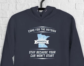 May include: A navy blue hoodie with a white outline of the state of Minnesota and the text "Come for the hotdish, stay because your car won't start."