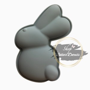 May include: Gray silicone bunny-shaped mold for baking or crafting.