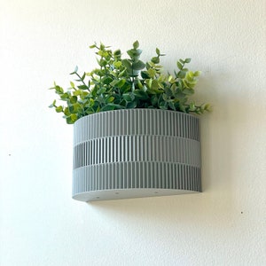 a planter hanging on the side of a wall