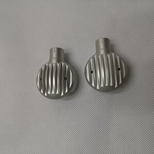 May include: Two silver metal round knobs with a grooved design. The knobs have a small hole on each side.