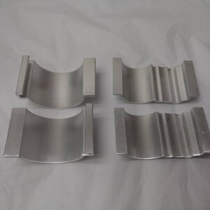 May include: Four silver metal rings, two with a smooth surface and two with a textured surface. The rings are all the same size and shape.