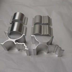 May include: Set of six silver metal brackets with decorative edges. The brackets are designed to be used as shelf supports.