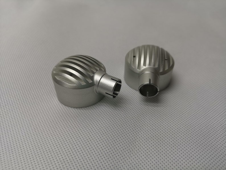 May include: Two silver metal microphone covers with a ribbed design. The covers have a small hole on the side.