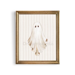 May include: A framed watercolor painting of a white ghost with two black eyes on a striped background.