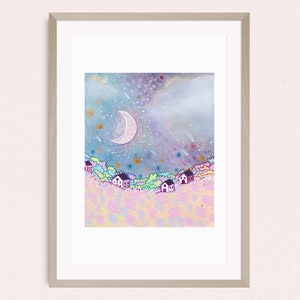 May include: A framed art print showing a whimsical night scene. The artwork depicts a crescent moon, stars, and a dreamy landscape with small houses. The colour palette includes soft blues, purples, and pinks, creating a serene and imaginative atmosphere.