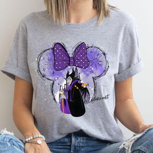 a woman wearing a mickey mouse t - shirt