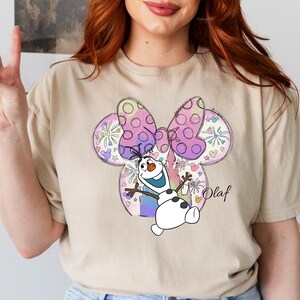 a woman with red hair wearing a t - shirt with a cartoon character on it