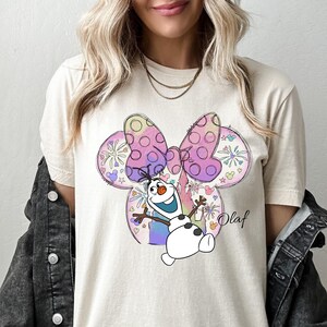 a woman wearing a mickey mouse t - shirt