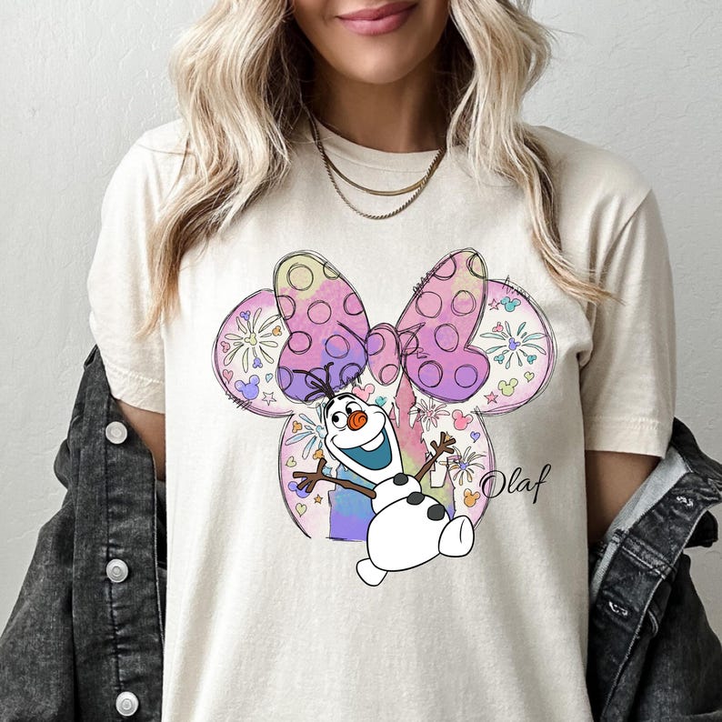 a woman wearing a mickey mouse t - shirt
